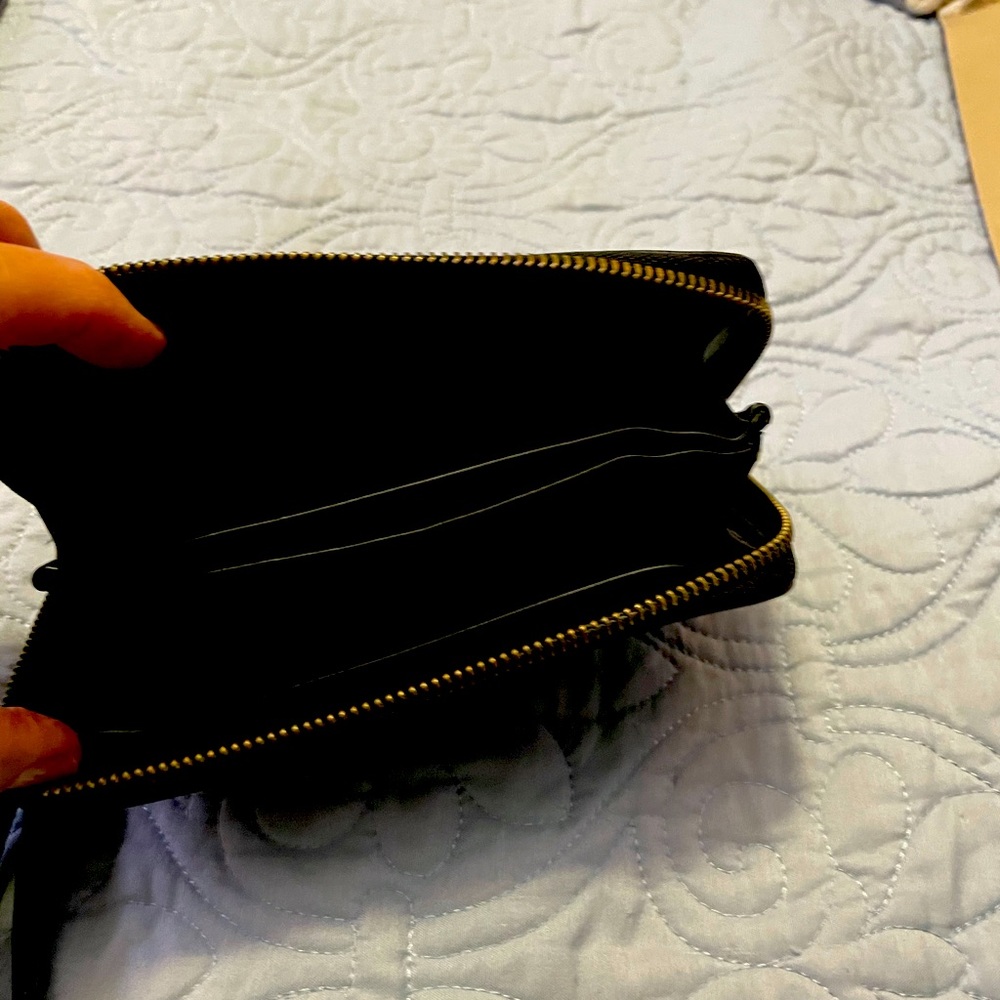 Gently used zip clutch bag.